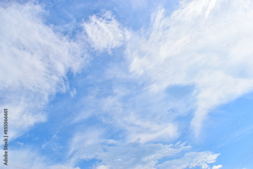 Poster beautiful blue sky and white fluffy group of clouds with sunrise in the morning, natural background