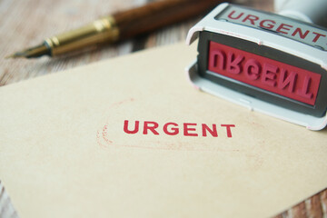 Red URGENT word stamp on a white paper 