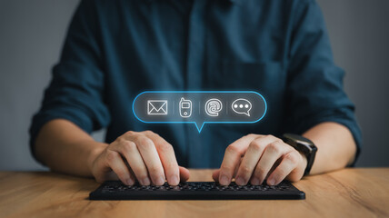 Customer support hotline Contact us people connection. Businessman using computer keyboard with the email, call phone, address, Chat message icons.