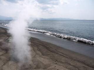 Steam rising from hot volcanic Black sand beach on Ibusuki coast