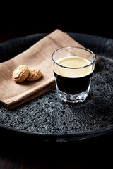 Coffee in glass cup on dark background. Close up. Copy space