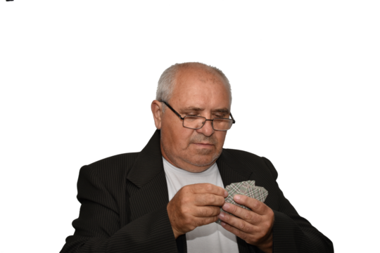 Portrait of an elderly man holding playing cards in his hands.