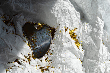 Metal gua sha scraper close up