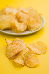 Crispy Potato Chips on Yellow Background