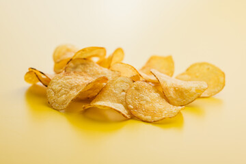 Crispy Potato Chips on Yellow Background