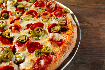 A view of a pepperoni and jalapeno pizza.