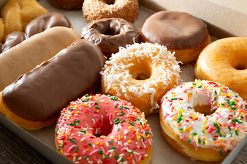 A view of a dozen donuts in a box.