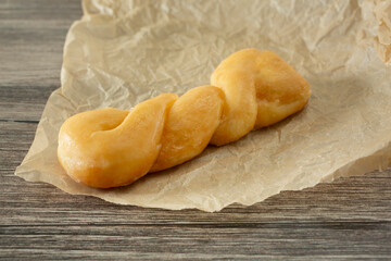 A view of a glazed twist donut.