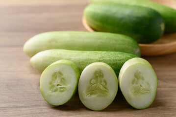 Sliced cucumber on wooden background, Organic vegetable, Food ingredient