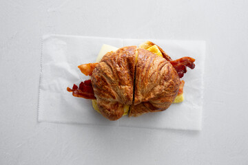 A top down view of a croissant breakfast sandwich.