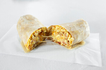 A view of a cheesy breakfast burrito.