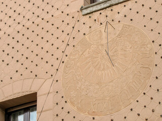 Detailed sundial on a decorated wall in Segovia