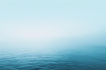 A vast expanse of water under a clear blue sky, A soft gradient of light blue tones blending seamlessly