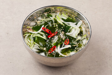 A food made by cutting cucumbers into small pieces, pickling them in salt or soy sauce, adding them to cold soup, and adding green onions, vinegar, sugar, and red pepper powder.
