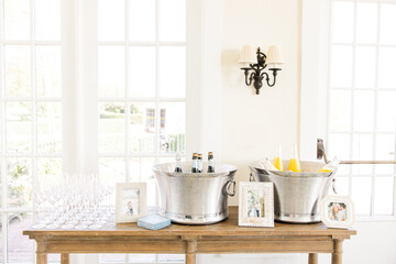 Beverage station with champagne and juice bottles in ice buckets