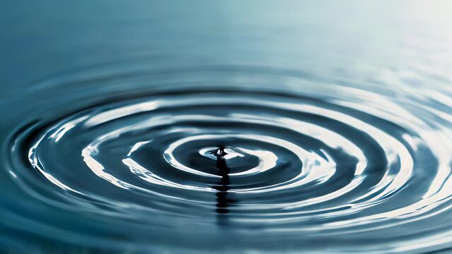 ripples on a smooth, dark blue water surface