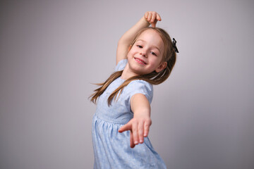 little girl dancing happy emotion hands above head portrait 