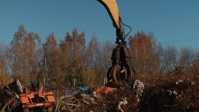 The crane loads scrap metal. selective focus.