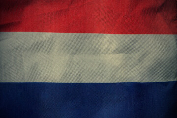 Netherlands nation flag on crumpled fabric background , country flag