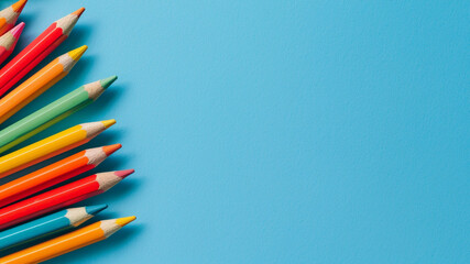 Fototapeta premium color pencils on blue background with copy space