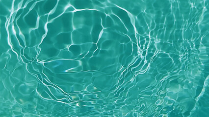 Blue water with ripples on the surface. Defocus blurred transparent blue colored clear calm water surface texture with splashes and bubbles. Water waves with shining pattern texture background.