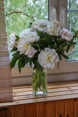 Blurred floral background. A bouquet of white peonies.