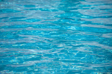 Ripple Water in swimming pool with sun reflection. Wavy water background.