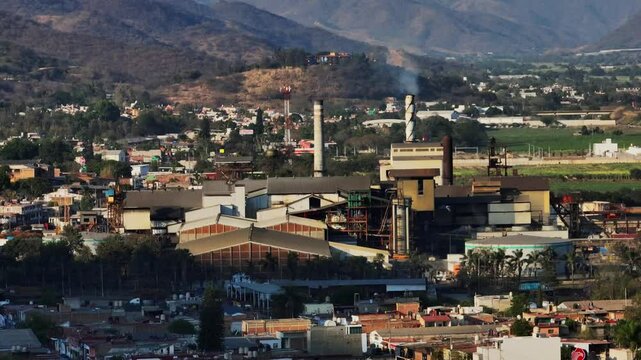 Establishing view of the sugar cane processing factory in Tamazula de Gordiano. Dolly out backward drone flight