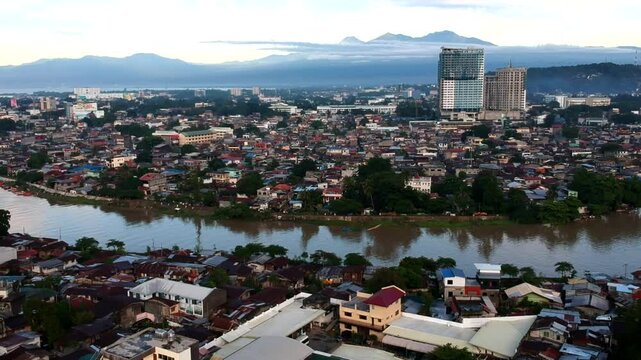 Aerial drone shots of Davao Cityscape reveal lush greenery, urban sprawl, Mount Apo backdrop, and serene coastal views, blending nature and modernity.