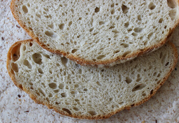 Two slices of domestic bread on lavash with sesame and flax seeds closeup texture background 
