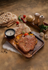 Bosnian Mix Grill PLJESKA, Two pieces of minced meat and served with Somun, Labnah (Kaymak), Bosnian sauce (Ajvar).