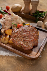 Bosnian Mix Grill PLJESKA, Two pieces of minced meat and served with Somun, Labnah (Kaymak), Bosnian sauce (Ajvar).