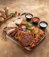 Assorted mix grills with tikka boti seekh kabab of chicken, beef, lamb, mutton bbq platter served in dish isolated on table top view of arabian food