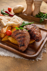 Assorted mix grills with tikka boti seekh kabab of chicken, beef, lamb, mutton bbq platter served in dish isolated on table top view of arabian food