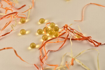Yellow small balls on a white background with multi-colored serpentine.