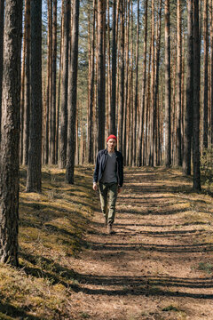 Man walks through the woods, hiking, time in nature.