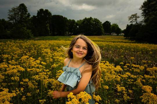 Close up of beautiful young girl yellow flower field