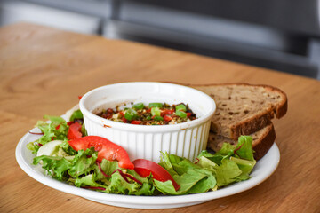 Snack in a white ceramic bowl with vegetables