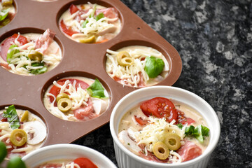 Pizza muffins with basil, olives, tomatoes