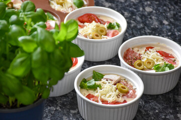 Pizza muffins with basil, olives, tomatoes