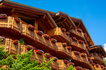 Wood Building with Balcony and Flower and Sunlight in Crans Montana, Valais, Switzerland.