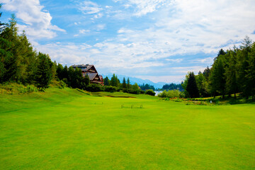 Golf Course with Mountain View and Clouds in a Sunny Summer Day in Crans Montana, Valais, Switzerland.