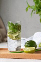 Non-alcohol mojito cocktail drink, summer refreshing soft drink, mocktail with limes and mint on wooden table with natural sunlight, lifestyle