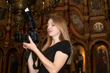 Photographer taking photo on ceremony in orthodox church	