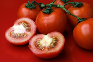 Close-up of fresh tomatoes on a red background