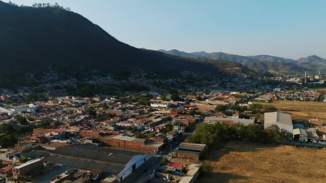 Aerial orbit overlooks Tamazula and the Cerro de la Mesa mountain in Mexico. Orbit aerial right to left