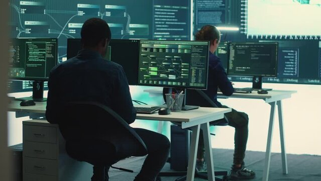 Cyber intelligence team of experts in a governmental hacking room, implementing ways to protect national secrets. Digital security, cyber surveillance and prevention of cyberterrorism. Camera A.