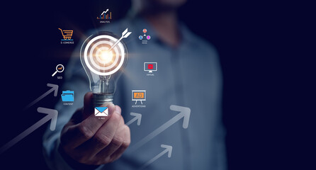 Fototapeta premium Business goal and target success concept, businessman holding goal of becoming a leader investing in assets Business and finance, arrow up, global economic trend analysis, Financial graph analysis.