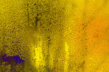 Wet glass. abstract yellow background.