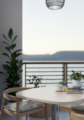 A wooden table with armchairs on a balcony with decorative plants and a beautiful nature view.